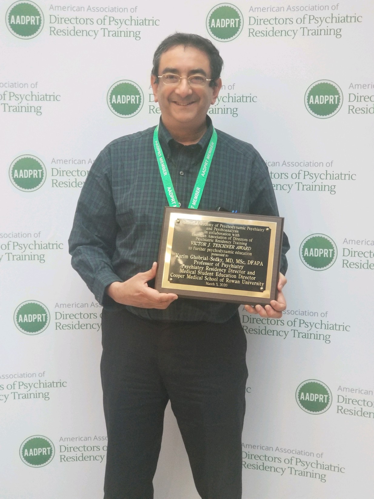 Dr. Sedky poses with award