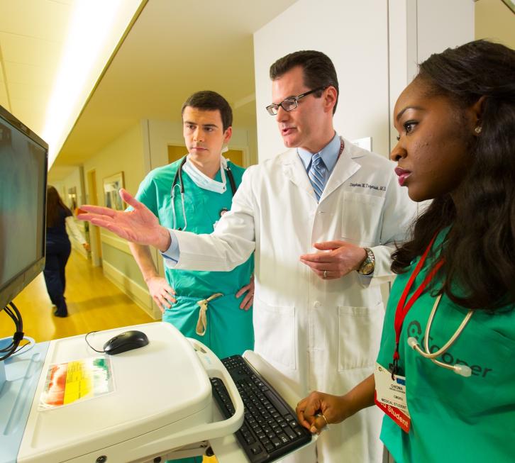 Dr. Trzeciak teaching two medical students at hospital